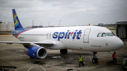 A Spirit Airlines Airbuys A320-200 airplane sits at a gate at the O'Hare Airport in Chicago.