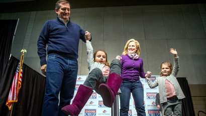 Republican presidential candidate Sen. Ted Cruz, R-Texas, and his wife Heidi swing their daughter Caroline, 7, as their younger daughter Catherine, 4, right, waves to members of the audience after Cruz spoke at a rally at the Five Sullivan Brothers Convention Center in Waterloo, Iowa, Saturday, Jan. 23, 2016.