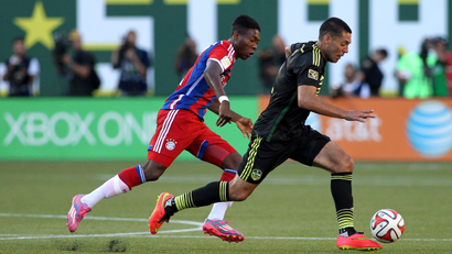 Aug 6, 2014; Portland, OR, USA; MLS All Stars midfielder Clint Dempsey (right) of the Seattle Sounders carries the ball away from Bayern Munich defenseman David Alaba (27) during the 2014 MLS All Star Game at Providence Park.
