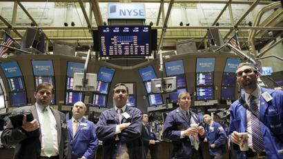 Traders gather on the floor of the New York Stock Exchange