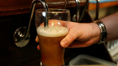 A barman pulls a pint of beer