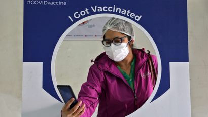 A healthcare worker takes a selfie after she received a dose of COVISHIELD at a hospital in Kolkata