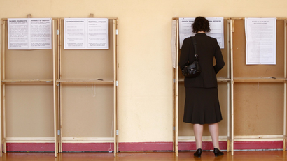 A voter fills out a ballot paper at a polling station, in Dublin on June 12, 2008