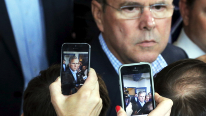 Reporters use their mobile phones to record potential 2016 Republican presidential candidate and former Florida Governor Jeb Bush as he answers questions after speaking at a business roundtable in Portsmouth, New Hampshire May 20, 2015.