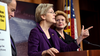 Sen. Elizabeth Warren, D-Mass., center, flanked by Sen. Charles Schumer, D-N.Y., left, and Sen. Debbie Sabenow, D-Mich., right, speaks to reporters on Capitol Hill in Washington, Thursday, July 30, 2015.