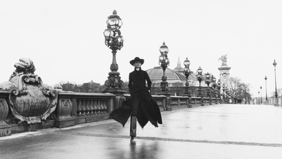 Model Chantal Dumont crosses the Alexandre III bridge in Paris.