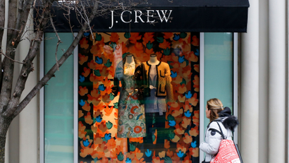In this Friday, Feb. 10, 2017, photo, a shopper passes a display in the window of a J. Crew store in the Shadyside shopping district of Pittsburgh. On Wednesday, March 15, 2017, the Commerce Department releases U.S. retail sales data for February. (AP Photo/Gene J. Puskar)