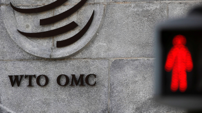 The logo of the World Trade Organization (WTO) at its headquarters next to a red traffic light in Geneva, Switzerland