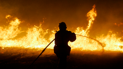 firefighter battles a fire