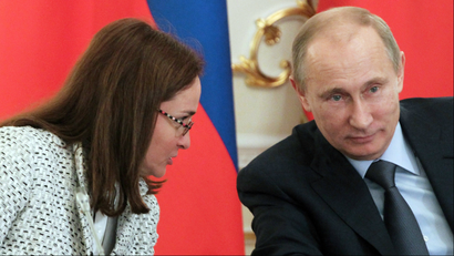 Russian President Vladimir Putin, right, listens to his aide Elvira Nabiullina