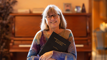 Donna Strickland, an associate professor at the University of Waterloo, poses with her paper that started her career 30 years ago, after winning the Nobel Prize for Physics at her home in Waterloo, Ontario, Canada October 2, 2018.