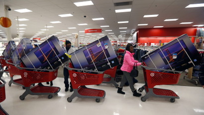 Thanksgiving Day holiday shoppers line up with television sets on discount at the Target retail store in Chicago