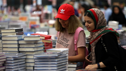 Visitors read books at the Big Bad Wolf Book Sale, which calls itself the world's biggest, hosted for the first time by Dubai