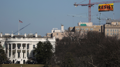 Greenpeace activists display a banner reading 'Resist' from a construction crane near the White House in downtown Washington.