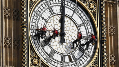 FILE- In this file photo dated Monday, Aug. 18, 2014, workers abseil outside the clock face as they clean Big Ben's clock tower of the Houses of Parliament in London. According to reports published Sunday Oct. 18, 2015, the chimes of Big Ben may fall silent for many months as urgent repairs are carried out to the clock and the tower, which must begin as soon as possible.