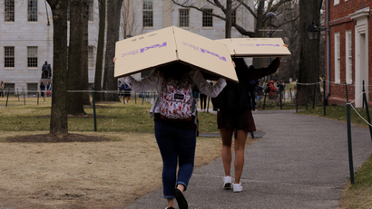 Students carry boxes to their dorms at Harvard University in Cambridge