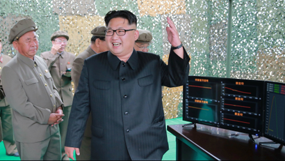 North Korean leader Kim Jong Un reacts during a test launch of ground-to-ground medium long-range ballistic rocket Hwasong-10 in this undated photo released by North Korea's Korean Central News Agency
