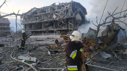 Emergency services attend a shelled building in Odesa.