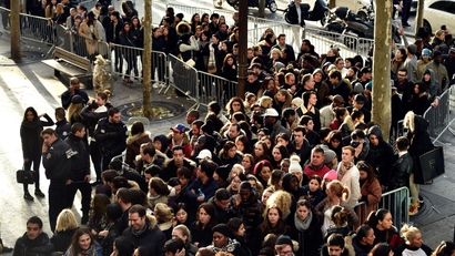 People wait to enter H&M before the Balmain X H&M Collection Launch at H&M Champs Elysees on November 5, 2015 in Paris, France.