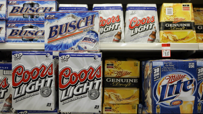 Products from Coors, Miller and Anheuser-Busch sit in a grocery store cooler.