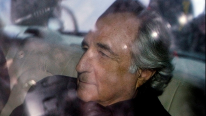 Bernard Madoff is escorted in a vehicle from Federal Court in New York January 5, 2009