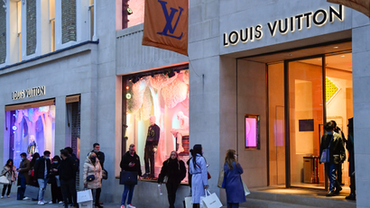 Shoppers queue to enter a Louis Vuitton store, as a second lockdown in England ends
