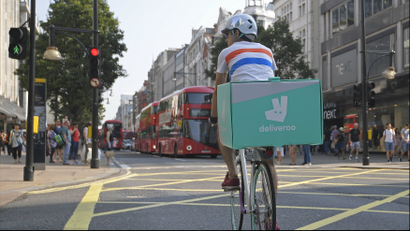 Deliveroo bike with rider in London, UK