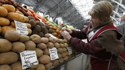 A vendor sells potatoes at the city market in St. Petersburg.