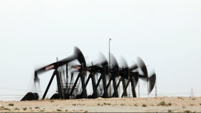A row of oil pumps work in the desert oil fields of Sakhir, Bahrain.