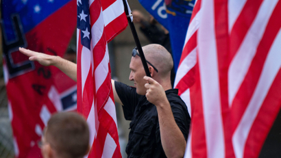 A member of a white supremacy group gives the fascist salute during a gathering in West Allis