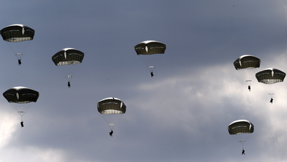 Troops from the U.S. Army's 173rd Infantry Brigade Combat Team parachute during a NATO-led exercise "Orzel Alert" held together with Canada's 3rd Battalion and Princess Patricia's Light Infantry, and Poland's 6th Airborne Brigade in Bledowska Desert in Chechlo, near Olkusz, south Poland May 5, 2014. The training includes parachuting, airborne operations and infantry skills.REUTERS/Kacper Pempel (POLAND - Tags: MILITARY POLITICS) - LR2EA551DC8X9