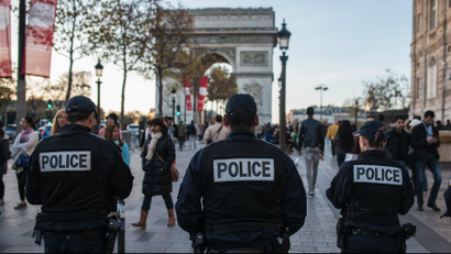 French police officers patrol on the Champs Elysees in Paris.