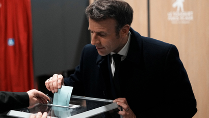 French President Emmanuel Macron votes in the first round of the presidential election.