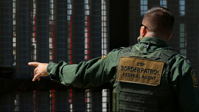 A border patrol officer next to the Mexico-US border.
