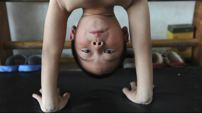 A young gymnast takes part in a training session for four to seven-year-olds at the gymnastics hall of a sports school in Jiaxing, Zhejiang province August 10, 2010. Chinese officials insist tough new eligibility rules will put a stop to the type of "age cheat" scandal that saw a gymnast stripped of her Olympic medal. REUTERS/Stringer (CHINA - Tags: SPORT GYMNASTICS) CHINA OUT. NO COMMERCIAL OR EDITORIAL SALES IN CHINA