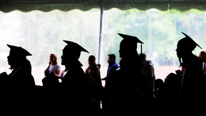 Graduating seniors line up to receive their diplomas during commencement