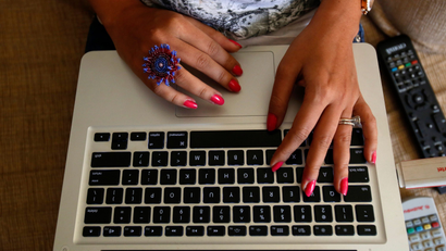 The hands of Malini Agarwal, blogger-in-chief of missmalini.com, are pictured as she blogs from her living room in Mumbai