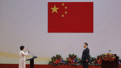 Chinese President Xi Jinping, right, administers the oath to Hong Kong's new Chief Executive Carrie Lam for a five-year term in office at the Hong Kong Convention and Exhibition Center in Hong Kong Saturday, July 1, 2017.