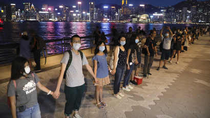 Demonstrators link hands as they gather at the Tsim Sha Tsui waterfront in Hong Kong, Friday, Aug. 23, 2019. Demonstrators were planning to form 40 kilometers (25 miles) of human chains Friday night to show their resolve. They said the "Hong Kong Way" was inspired by the "Baltic Way," when people in the Baltic states joined hands 30 years ago in a protest against Soviet control.