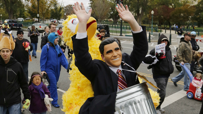 Eric Cardwell wears a costume depicting Big Bird carrying U.S. Republican presidential candidate Mitt Romney in a trash can during a Million Muppet March in support of federal funding for public television, in Washington, November 3, 2012.