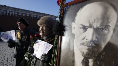Communist supporters hold portraits of Soviet state founder Lenin during a wreath laying ceremony to Lenin's mausoleum on Moscow's Red Square