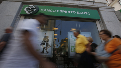 People walk past an office of Portuguese bank Banco Espirito Santo in Lisbon