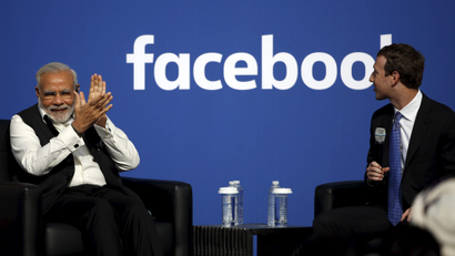 Indian Prime Minister Narendra Modi applauds as Facebook CEO Mark Zuckerberg speaks on stage during a town hall at Facebook's headquarters in Menlo Park, California