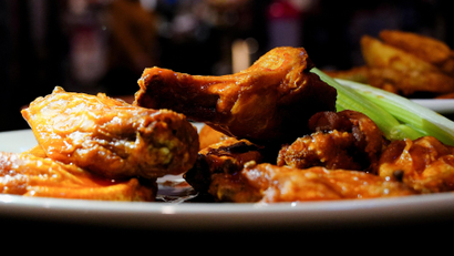 Plate of buffalo wings and celery. 