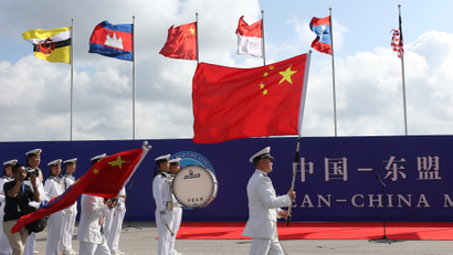 Members of the Chinese People's Liberation Army (PLA) and navy hold Chinese flags during the opening ceremony of the first China-ASEAN Maritime Exercise in Zhanjiang.