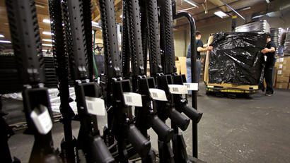 A rack of AR-15 rifles stand to be individually packaged as workers move a pallet of rifles for shipment at the Stag Arms company in New Britain, Conn., Wednesday, April 10, 2013. A Connecticut gun-maker announced on Wednesday it intends to leave the state, just six days after passage of restrictive gun control legislation, while another manufacturer, Stag Arms, which employs about 230 workers, says its customers are urging it to "pick up and leave."