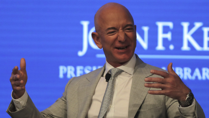 Jeff Bezos looking particularly happy at a conference
