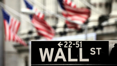 A Wall Street sign is shown in front of the New York Stock Exchange, Thursday, April 22, 2010. President Barack Obama gives a speech later in the day in New York regarding regulation of the financial community.