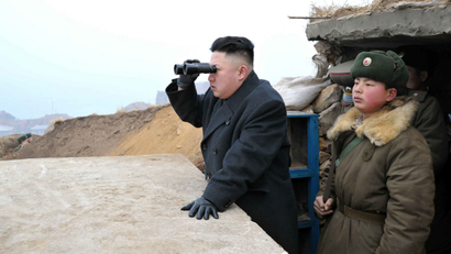 In this March 7, 2013 photo released by the Korean Central News Agency (KCNA) and distributed March 8, 2013 by the Korea News Service, North Korean leader Kim Jong Un, center, uses binoculars to look at the South's territory from an observation post at the military unit on Jangjae islet, located in the southernmost part of the southwestern sector of North Korea's border with South Korea.