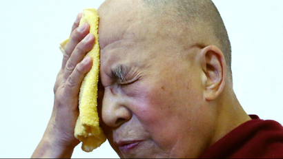 Tibet's exiled spiritual leader the Dalai Lama wipes his face during an international conference of Tibet support groups in Brussels, Belgium, September 8, 2016.